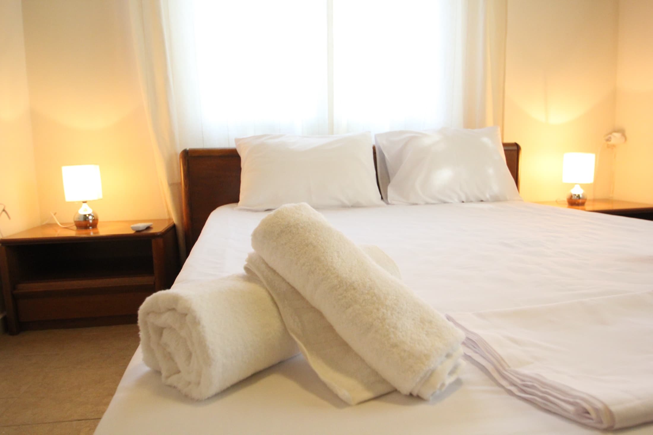 Double bedroom with crisp white linens at Fistiki House